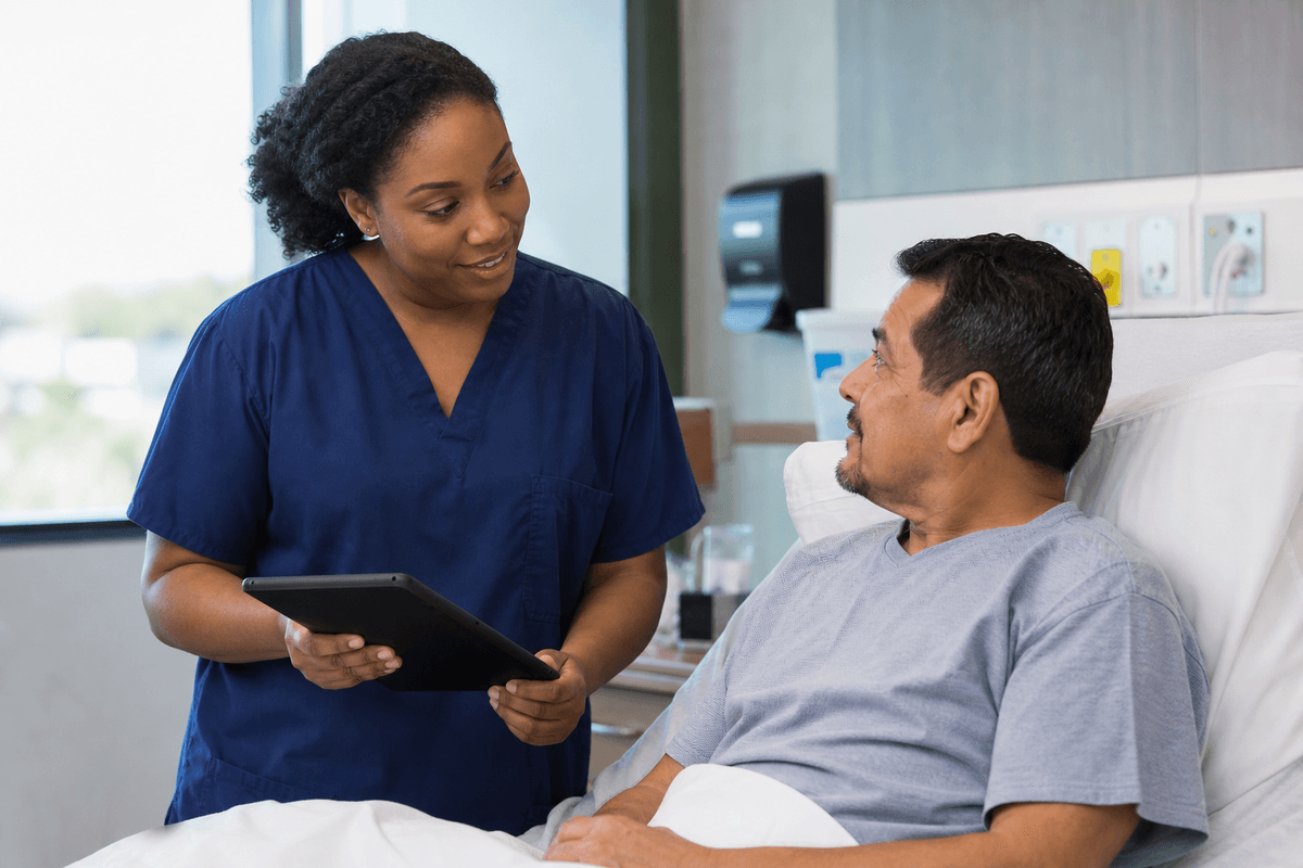 Nurse conducting bedside rounding with a patient