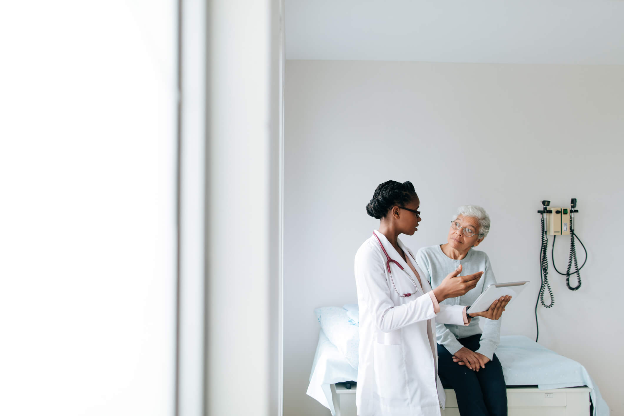 Doctor speaking with a patient in an exam room