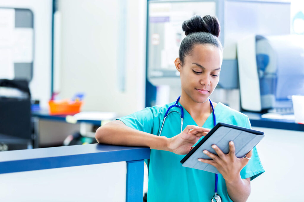 A nurse viewing healthcare data on a tablet