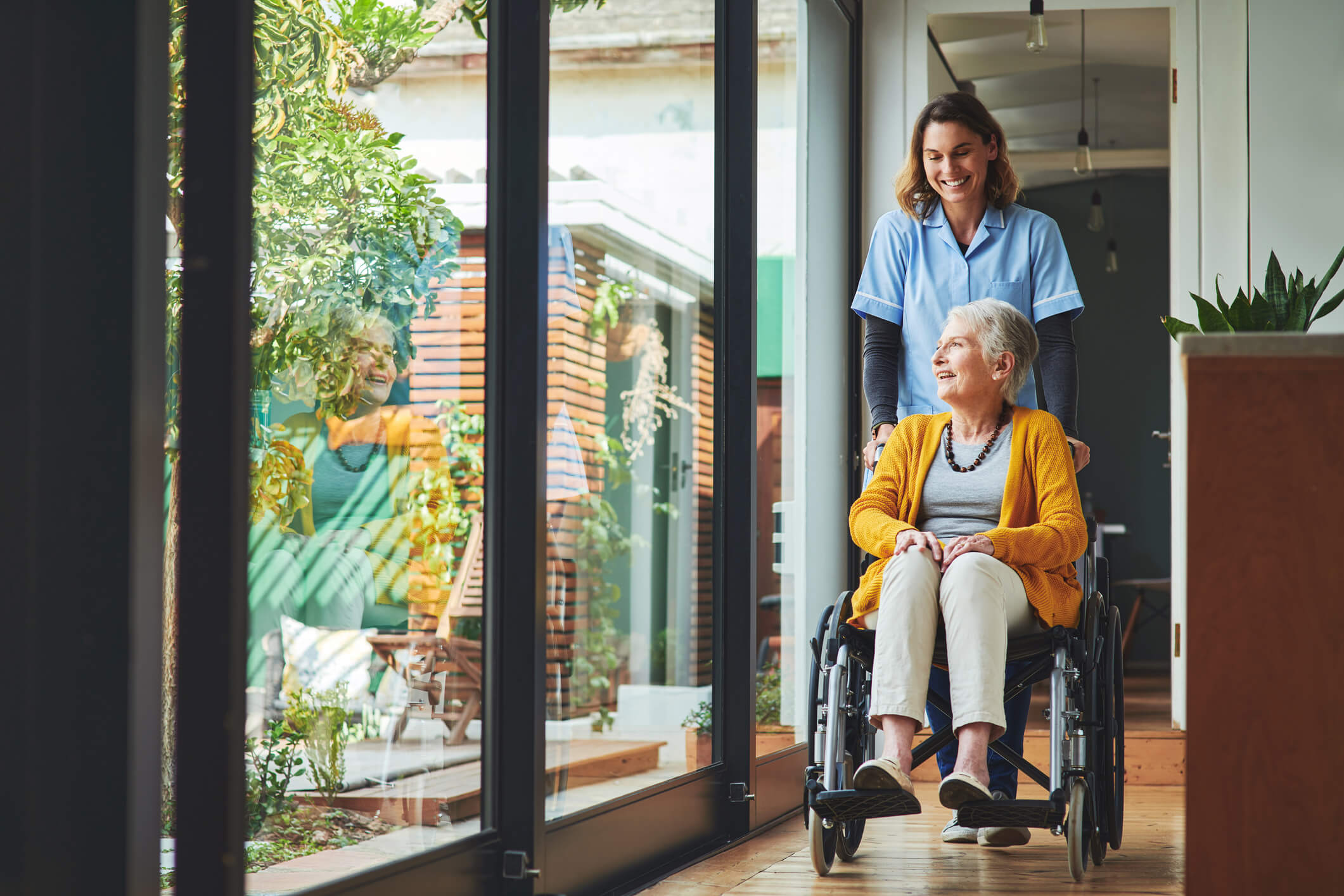 Woman pushing her grandmother in a wheel chair